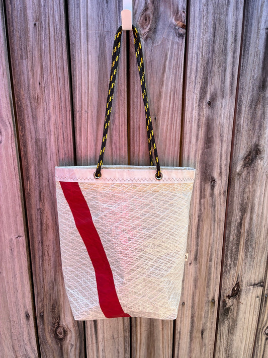 The Haul sailcloth tote bag, C&C 35 'Phoenix' laminate sail – front view with red stripe – handmade sailcloth bag from recycled sails